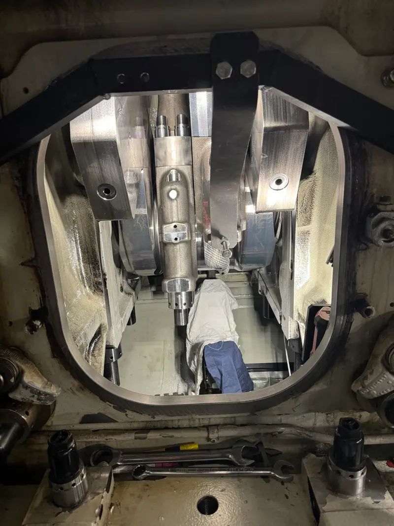 Technician rigging shaft assembly with chain hoist