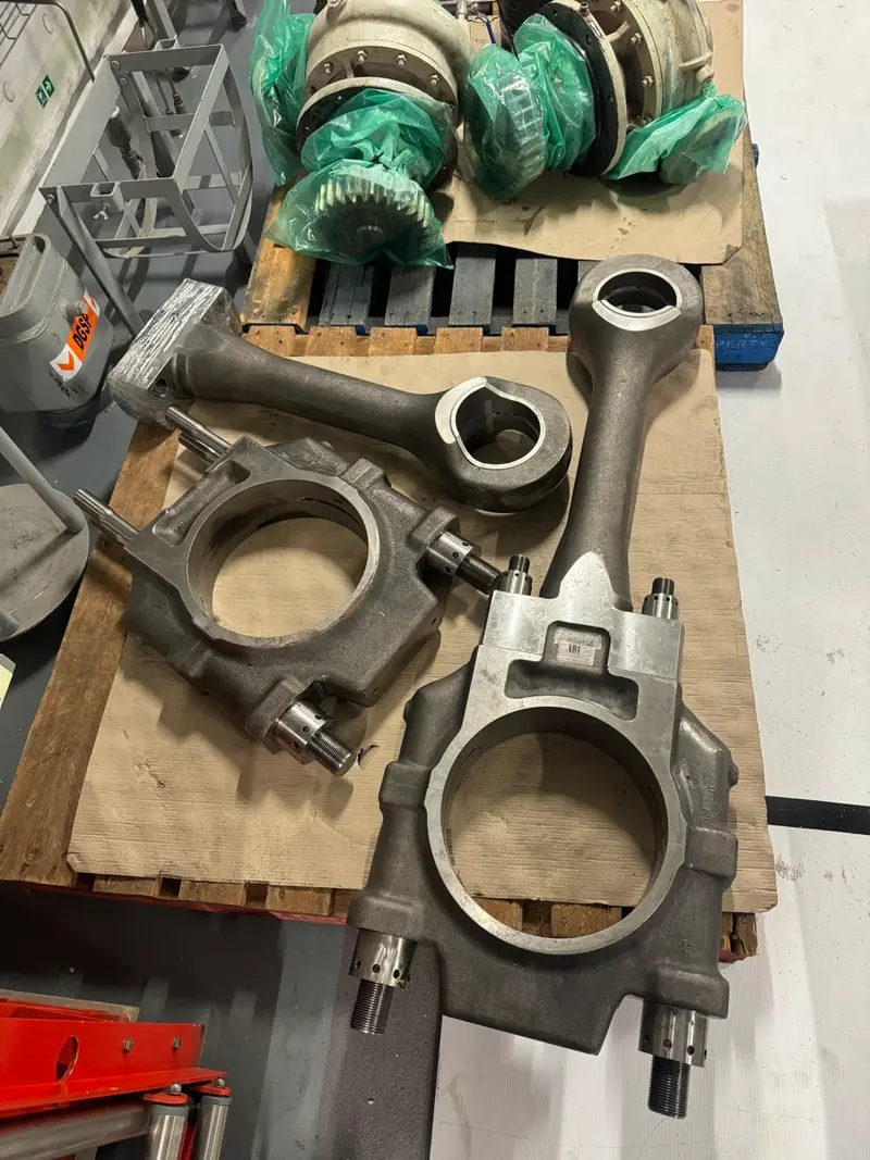 Machined connecting rods and engine components in workshop